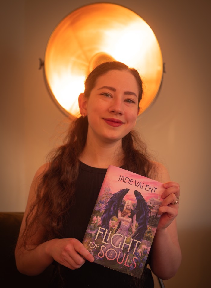 A photo of the author holding up the hardcover novel.